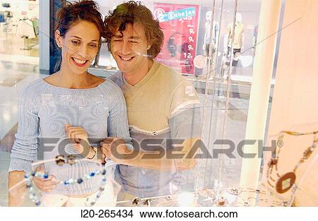 Couple in shopping center, looking at shop windows View Large Photo Image Picture - Couple in shopping center, looking at shop windows. Fotosearch