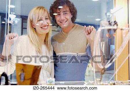 Couple in shopping center, looking at shop windows View Large Photo Image Picture - Couple in shopping center, looking at shop windows. Fotosearch