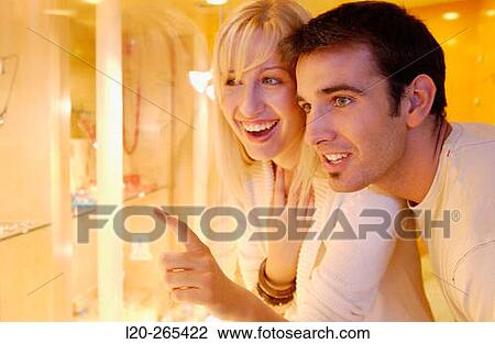 Couple in shopping center, looking at jewelry View Large Photo Image Stock Image - Couple in shopping center, looking at jewelry. Fotosearch