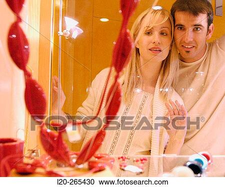 Couple in shopping center, looking at shop windows View Large Photo Image Stock Image - Couple in shopping center, looking at shop windows. Fotosearch