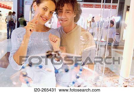Couple in shopping center, looking at shop windows View Large Photo Image Stock Image - Couple in shopping center, looking at shop windows. Fotosearch