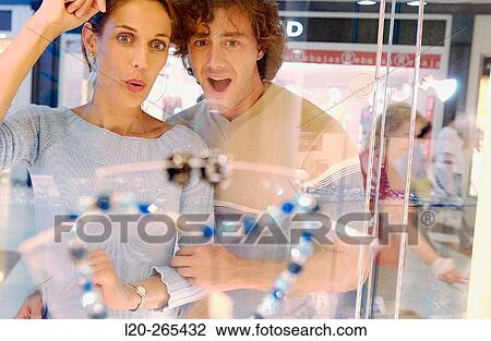 Couple in shopping center, looking at shop windows View Large Photo Image Stock Image - Couple in shopping center, looking at shop windows. Fotosearch