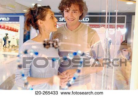 Couple in shopping center, looking at shop windows View Large Photo Image Stock Image - Couple in shopping center, looking at shop windows. Fotosearch