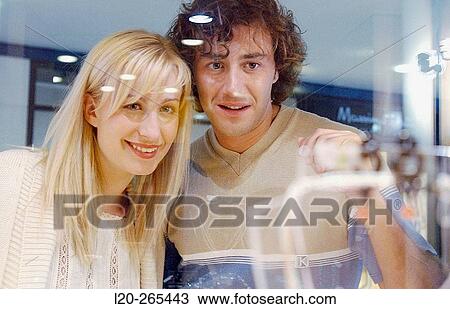 Couple in shopping center, looking at shop windows View Large Photo Image Stock Image - Couple in shopping center, looking at shop windows. Fotosearch