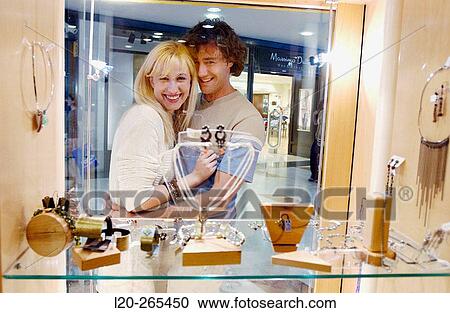 Couple in shopping center, looking at shop windows View Large Photo Image Stock Image - Couple in shopping center, looking at shop windows. Fotosearch