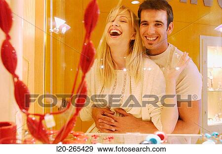 Stock Photo - Couple in shopping center, looking at shop windows. Fotosearch