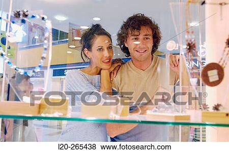 Couple in shopping center, looking at shop windows View Large Photo Image Stock Photo - Couple in shopping center, looking at shop windows. Fotosearch