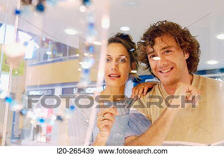 Couple in shopping center, looking at shop windows View Large Photo Image Stock Photo - Couple in shopping center, looking at shop windows. Fotosearch
