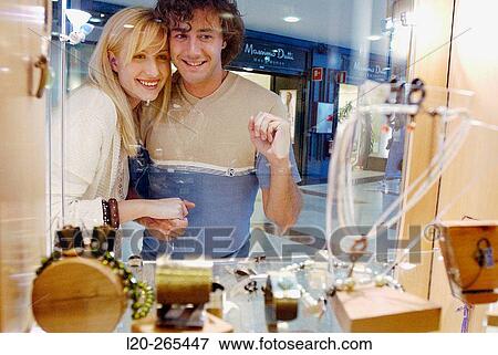 Couple in shopping center, looking at shop windows View Large Photo Image Stock Photo - Couple in shopping center, looking at shop windows. Fotosearch