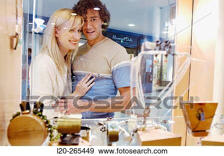 Couple in shopping center, looking at shop windows View Large Photo Image Stock Photo - Couple in shopping center, looking at shop windows. Fotosearch