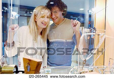 Couple in shopping center, looking at shop windows View Large Photo Image Stock Photography - Couple in shopping center, looking at shop windows. Fotosearch