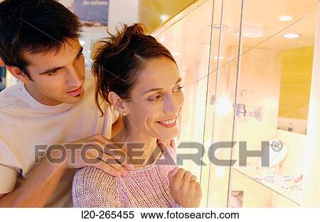 Couple in shopping center, looking at jewelry View Large Photo Image Stock Photography - Couple in shopping center, looking at jewelry. Fotosearch