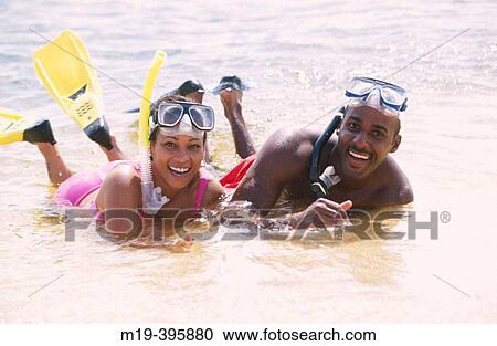 couple in snorkling gear lying on the beach View Large Photo Image Stock Image - couple in snorkling gear lying on the beach. Fotosearch