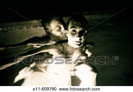 Stock Image - Couple in swimming pool. Fotosearch