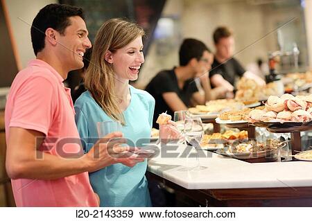 Couple in tapas bar, Basque Country, Spain View Large Photo Image Stock Photo - Couple in tapas bar, Basque Country, Spain. Fotosearch