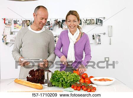 Couple in the kitchen View Large Photo Image Stock Photo - Couple in the kitchen. Fotosearch