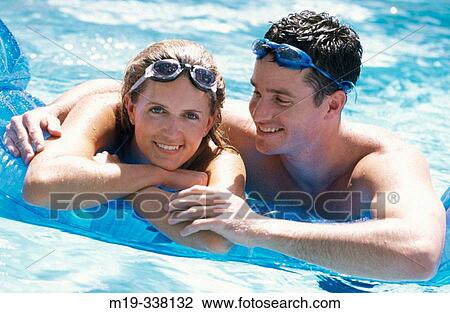 Couple in the swimming pool View Large Photo Image Stock Image - Couple in the swimming pool. Fotosearch