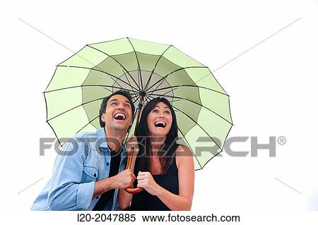 Couple in their 30's smiling under umbrella. View Large Photo Image Stock Photography - Couple in their 30's smiling under umbrella.. Fotosearch