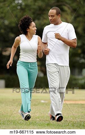 Couple jogging in a park View Large Photo Image Stock Photography - Couple jogging in a park. Fotosearch