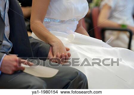 Picture - Couple joining hands during wedding ceremony, Firenze, Tuscany, Italy.. Fotosearch