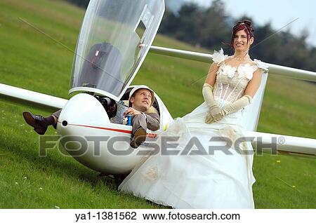 Couple just married posing near a glider plane, France View Large Photo Image Stock Image - Couple just married posing near a glider plane, France. Fotosearch