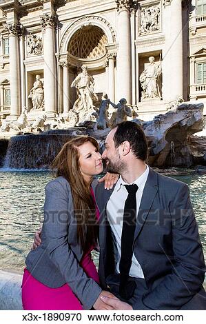 Stock Image - Couple kissing at Piazza Fontana di Trevi Rome Italy. Fotosearch