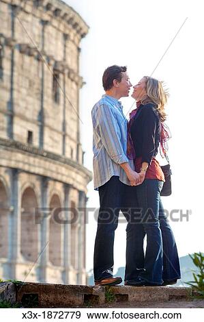 Couple kissing at the roman Colosseum Rome Italy View Large Photo Image Stock Photo - Couple kissing at the roman Colosseum Rome Italy. Fotosearch