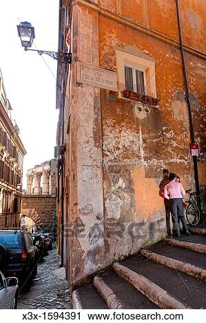 Stock Image - Couple kissing in a roman alleyway Rome Italy. Fotosearch
