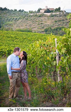 Couple kissing in a vineyard underneath Greve in Chianti Italy View Large Photo Image Stock Photo - Couple kissing in a vineyard underneath Greve in Chianti Italy. Fotosearch