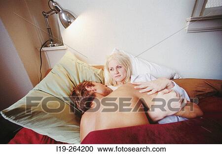 Couple kissing in bed View Large Photo Image Stock Image - Couple kissing in bed. Fotosearch