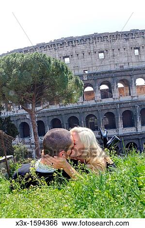 Couple kissing in front of the Roman Colosseum Rome Italy View Large Photo Image Stock Photograph - Couple kissing in front of the Roman Colosseum Rome Italy. Fotosearch