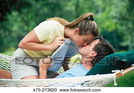 Couple kissing in hammock View Large Photo Image Stock Image - Couple kissing in hammock. Fotosearch