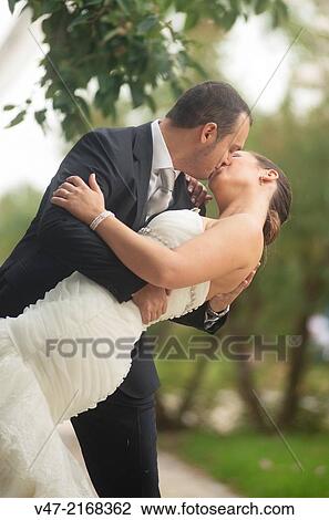 Couple kissing in the park, with a kiss of cinema View Large Photo Image Stock Image - Couple kissing in the park, with a kiss of cinema. Fotosearch