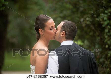 Couple kissing in the park, with a kiss of cinema View Large Photo Image Stock Photo - Couple kissing in the park, with a kiss of cinema. Fotosearch