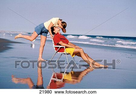 Couple kissing on beach View Large Photo Image Stock Image - Couple kissing on beach. Fotosearch