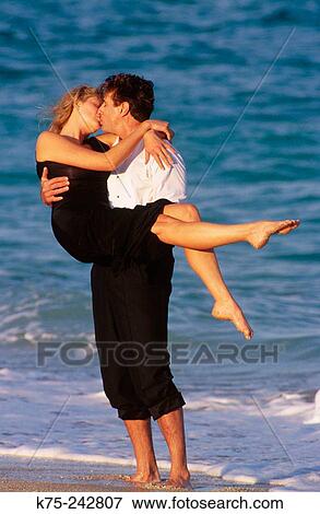 Couple kissing on the beach View Large Photo Image Stock Photo - Couple kissing on the beach. Fotosearch