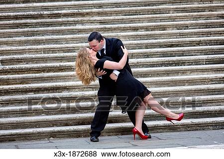 Stock Photo - Couple kissing on the stairs in Rome Italy. Fotosearch