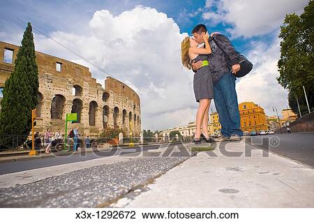 Couple kissing on the street before the Roman Colosseum in Rome Italy View Large Photo Image Stock Image - Couple kissing on the street before the Roman Colosseum in Rome Italy. Fotosearch