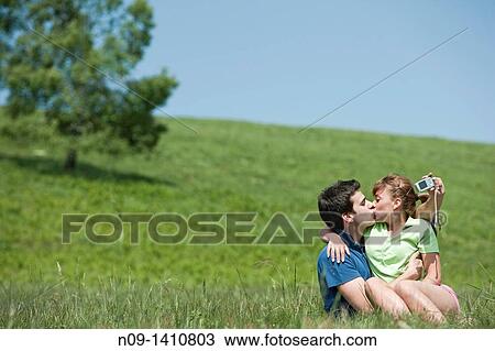 Couple kissing outdoors View Large Photo Image Stock Image - Couple kissing outdoors. Fotosearch
