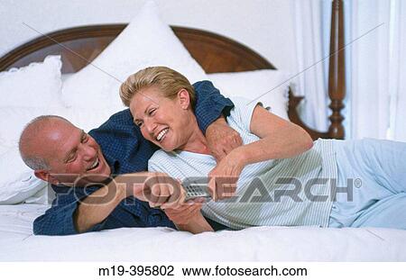 couple laughing on a bed View Large Photo Image Stock Image - couple laughing on a bed. Fotosearch