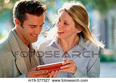 couple looking at a gift View Large Photo Image Stock Photo - couple looking at a gift. Fotosearch