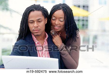 Stock Photography - couple looking at a laptop. Fotosearch