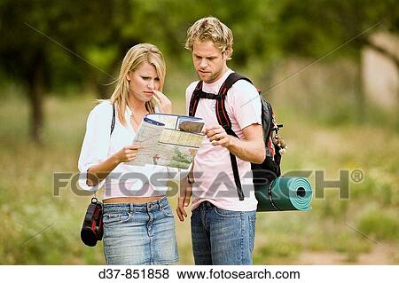 Couple looking at a map in a country trip View Large Photo Image Stock Photo - Couple looking at a map in a country trip. Fotosearch