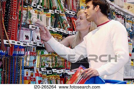 Couple looking at electronic price displays at the pets section of Eroski shopping center. These displays are updated by remote control. Urbil. Usurbil. Guipuzcoa. Basque Country. Spain View Large Photo Image Picture - Couple looking at electronic price displays at the pets section of Eroski shopping center. These displays are updated by remote control. Urbil. Usurbil. Guipuzcoa. Basque Country. Spain. Fotosearch