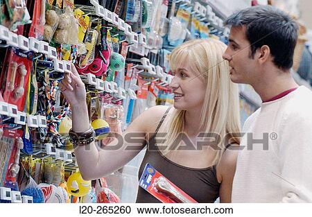 Couple looking at electronic price displays at the pets section of Eroski shopping center. These displays are updated by remote control. Urbil. Usurbil. Guipuzcoa. Basque Country. Spain View Large Photo Image Stock Image - Couple looking at electronic price displays at the pets section of Eroski shopping center. These displays are updated by remote control. Urbil. Usurbil. Guipuzcoa. Basque Country. Spain. Fotosearch