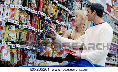 Couple looking at electronic price displays at the pets section of Eroski shopping center. These displays are updated by remote control. Urbil. Usurbil. Guipuzcoa. Basque Country. Spain View Large Photo Image Stock Image - Couple looking at electronic price displays at the pets section of Eroski shopping center. These displays are updated by remote control. Urbil. Usurbil. Guipuzcoa. Basque Country. Spain. Fotosearch