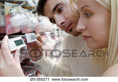 Couple looking at electronic price displays at Eroski shopping center. These displays are updated by remote control. Urbil. Usurbil. Guipuzcoa. Basque Country. Spain View Large Photo Image Stock Image - Couple looking at electronic price displays at Eroski shopping center. These displays are updated by remote control. Urbil. Usurbil. Guipuzcoa. Basque Country. Spain. Fotosearch