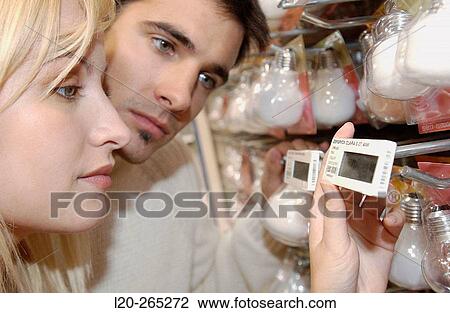 Couple looking at electronic price displays at Eroski shopping center. These displays are updated by remote control. Urbil. Usurbil. Guipuzcoa. Basque Country. Spain View Large Photo Image Stock Image - Couple looking at electronic price displays at Eroski shopping center. These displays are updated by remote control. Urbil. Usurbil. Guipuzcoa. Basque Country. Spain. Fotosearch
