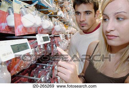 Couple looking at electronic price displays at Eroski shopping center. These displays are updated by remote control. Urbil. Usurbil. Guipuzcoa. Basque Country. Spain View Large Photo Image Stock Photo - Couple looking at electronic price displays at Eroski shopping center. These displays are updated by remote control. Urbil. Usurbil. Guipuzcoa. Basque Country. Spain. Fotosearch