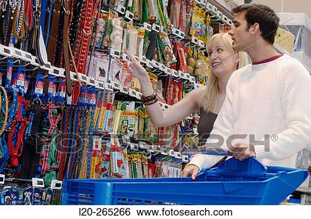 Couple looking at electronic price displays at the pets section of Eroski shopping center. These displays are updated by remote control. Urbil. Usurbil. Guipuzcoa. Basque Country. Spain View Large Photo Image Stock Photograph - Couple looking at electronic price displays at the pets section of Eroski shopping center. These displays are updated by remote control. Urbil. Usurbil. Guipuzcoa. Basque Country. Spain. Fotosearch